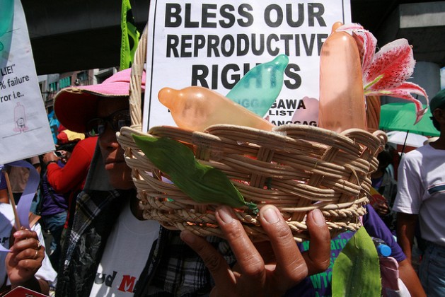 Manifestantes com uma cesta de preservativos no Dia Internacional da Mulher em Manila. Foto: Kara Santos/IPS